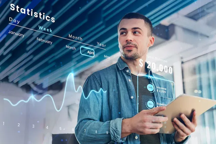 Man with a tablet in front of overlaid statistics and income graphics